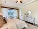 Main bedroom with large windows, tray ceiling, and private access to patio at 2683 Wyndsor Oaks Way, Winter Haven, FL 33884