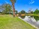 Peaceful pond with a charming bridge in a tranquil setting at 2683 Wyndsor Oaks Way, Winter Haven, FL 33884