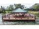 Lakeside gazebo with seating on a wooden deck at 2861 Attwater Loop, Winter Haven, FL 33884