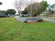 Imperial Harbours community sign is displayed on the lawn, with the parking area and condos in the background at 333 Lake Howard Nw Dr # 202-A, Winter Haven, FL 33880