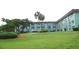 A picturesque exterior view of a multi-story residential building with well-manicured lawn and landscaped greenery at 333 Lake Howard Nw Dr # 202-A, Winter Haven, FL 33880