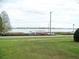 Lush green lawn view to waterfront property featuring a private dock and stunning lake views at 333 Lake Howard Nw Dr # 202-A, Winter Haven, FL 33880