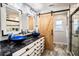 Modern bathroom with double sinks, a marble countertop, and a barn door at 3340 Crump Rd, Winter Haven, FL 33881