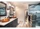 Elegant bathroom with copper sinks, marble countertops, and a walk-in shower at 3340 Crump Rd, Winter Haven, FL 33881