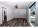 Simple bedroom with wood-look flooring, a window, and an ensuite bathroom at 3340 Crump Rd, Winter Haven, FL 33881