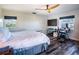 Bedroom with a large bed, home office space, and hardwood floors at 3340 Crump Rd, Winter Haven, FL 33881