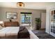 Bright bedroom with a large window, wooden dresser, and comfortable bed at 3340 Crump Rd, Winter Haven, FL 33881