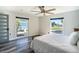 Bedroom with a ceiling fan, large windows, and hardwood flooring at 3340 Crump Rd, Winter Haven, FL 33881
