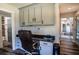 Home office with built-in desk and view into adjacent living area at 3340 Crump Rd, Winter Haven, FL 33881