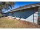 House back view, showcasing a large backyard and partial water view at 3340 Crump Rd, Winter Haven, FL 33881