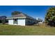 Side view of the house, highlighting the light blue exterior and landscaping at 3340 Crump Rd, Winter Haven, FL 33881