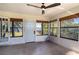 Sunroom with water views, featuring tile floors, a ceiling fan, and multiple windows at 3340 Crump Rd, Winter Haven, FL 33881