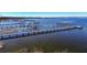 Stunning aerial of multiple long private wooden docks extending over calm water at 3340 Crump Rd, Winter Haven, FL 33881