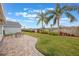 Landscaped backyard with palm trees and patio at 340 Lake Suzanne Dr, Lake Wales, FL 33859