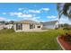 Home's exterior with patio and grassy backyard at 340 Lake Suzanne Dr, Lake Wales, FL 33859