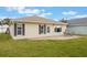 Home's exterior with patio and grassy backyard at 340 Lake Suzanne Dr, Lake Wales, FL 33859
