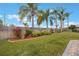 Backyard with lush landscaping and a wooden fence at 340 Lake Suzanne Dr, Lake Wales, FL 33859