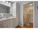 Bathroom with vanity, shower, and linen storage at 340 Lake Suzanne Dr, Lake Wales, FL 33859