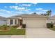Tan one-story house with a two-car garage and well-manicured lawn at 340 Lake Suzanne Dr, Lake Wales, FL 33859