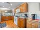 Kitchen with wood cabinets, white appliances, and breakfast bar at 340 Lake Suzanne Dr, Lake Wales, FL 33859