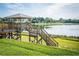 Wooden gazebo overlooking a serene lake at 340 Lake Suzanne Dr, Lake Wales, FL 33859