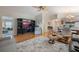 Spacious living room with hardwood floors, comfortable seating, and large TV at 340 Lake Suzanne Dr, Lake Wales, FL 33859