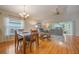 Spacious living room with hardwood floors, comfortable seating, and access to a sunroom at 340 Lake Suzanne Dr, Lake Wales, FL 33859