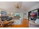 Open concept living room with hardwood floors, comfortable seating, and access to a sunroom at 340 Lake Suzanne Dr, Lake Wales, FL 33859