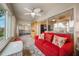 Sunroom with red couch, view into bedroom and another room at 340 Lake Suzanne Dr, Lake Wales, FL 33859