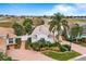 Aerial view of single-story house with landscaped yard and brick driveway at 3457 Raleigh Dr, Winter Haven, FL 33884