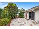 Hexagon paved patio with lush landscaping and wooden soldier statue at 3457 Raleigh Dr, Winter Haven, FL 33884