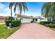 House exterior featuring brick driveway and lush landscaping at 3457 Raleigh Dr, Winter Haven, FL 33884
