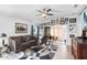 Living room with ceiling fan, brown leather sofa, and gallery wall at 3457 Raleigh Dr, Winter Haven, FL 33884