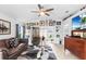Bright living room featuring a comfy leather sofa, large TV, and gallery wall at 3457 Raleigh Dr, Winter Haven, FL 33884