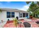 Red brick paved patio with seating area and tropical landscaping at 3457 Raleigh Dr, Winter Haven, FL 33884