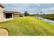 Spacious backyard with a patio overlooking a canal at 3834 Litchfield Loop, Lake Wales, FL 33859