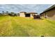Large backyard with expansive green lawn and home view at 3834 Litchfield Loop, Lake Wales, FL 33859