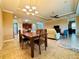 Spacious dining area with a large wooden table and chandelier at 3834 Litchfield Loop, Lake Wales, FL 33859
