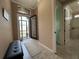 Light-filled entryway with view of backyard and bathroom at 3834 Litchfield Loop, Lake Wales, FL 33859