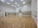 Indoor court with basketball hoop and mirrored walls for fitness at 3834 Litchfield Loop, Lake Wales, FL 33859