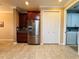 Modern kitchen features stainless steel fridge and ample cabinetry at 3834 Litchfield Loop, Lake Wales, FL 33859