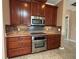 Kitchen with stainless steel appliances and wood cabinets at 3834 Litchfield Loop, Lake Wales, FL 33859