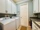 Laundry room with washer, dryer, and ample cabinet space at 3834 Litchfield Loop, Lake Wales, FL 33859