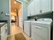 Bright laundry room with washer, dryer, and cabinets at 3834 Litchfield Loop, Lake Wales, FL 33859