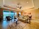 Bright living room with tile floors, comfy seating, and view to backyard at 3834 Litchfield Loop, Lake Wales, FL 33859