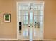 Bright home office features glass French doors and built-in shelving at 3834 Litchfield Loop, Lake Wales, FL 33859
