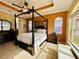 Spacious Primary bedroom with a king-size bed and large windows at 3834 Litchfield Loop, Lake Wales, FL 33859