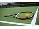 Tennis racquet and ball on a green court at 3834 Litchfield Loop, Lake Wales, FL 33859