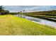 Serene canal-front property with green grass and trees at 3834 Litchfield Loop, Lake Wales, FL 33859