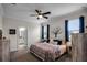 Spacious bedroom with large bed, ceiling fan, and en-suite bathroom at 3946 Bedford Ave, Winter Haven, FL 33884